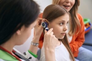 ENT doctor examining a child’s ear during Pediatric ENT Disorder Treatment in Bhopal
